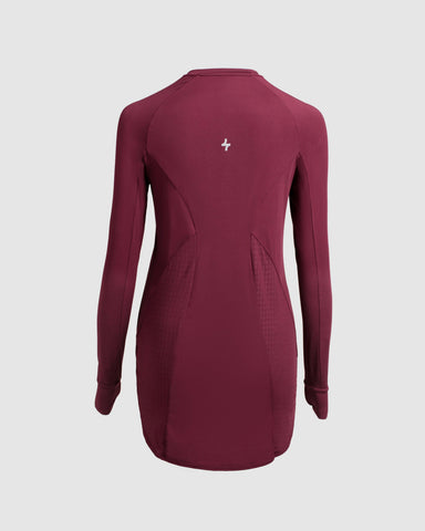 Back view of a modest maroon MOD LONG SLEEVE T-SHIRT by Qynda with mesh panels under the arms, featuring a Qynda logo centered below the neck and crafted from super light material.