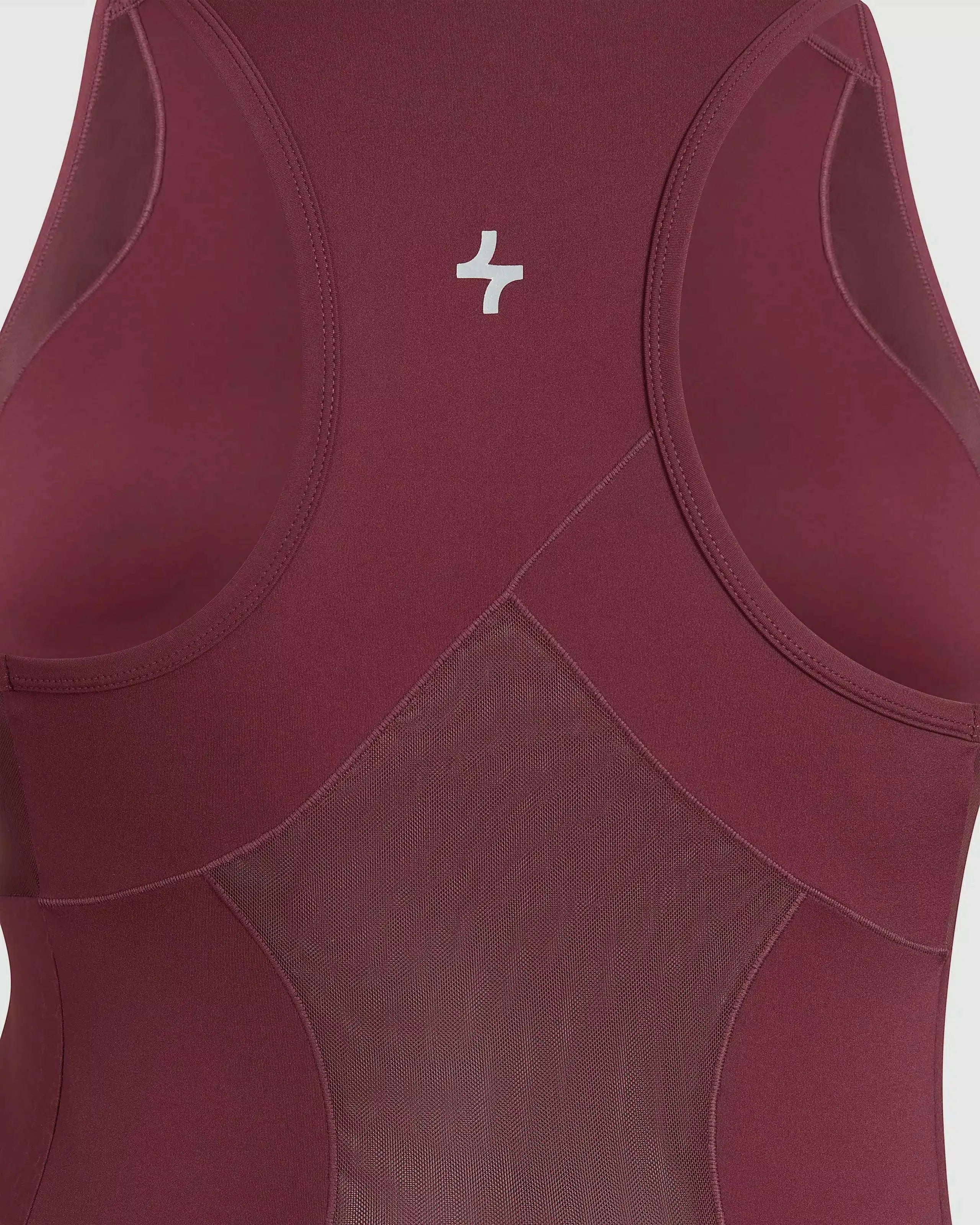 Close view of Maroon colored BADA TANK TOP with qynda logo, high neckline and mesh back and sides isolated on a white background.