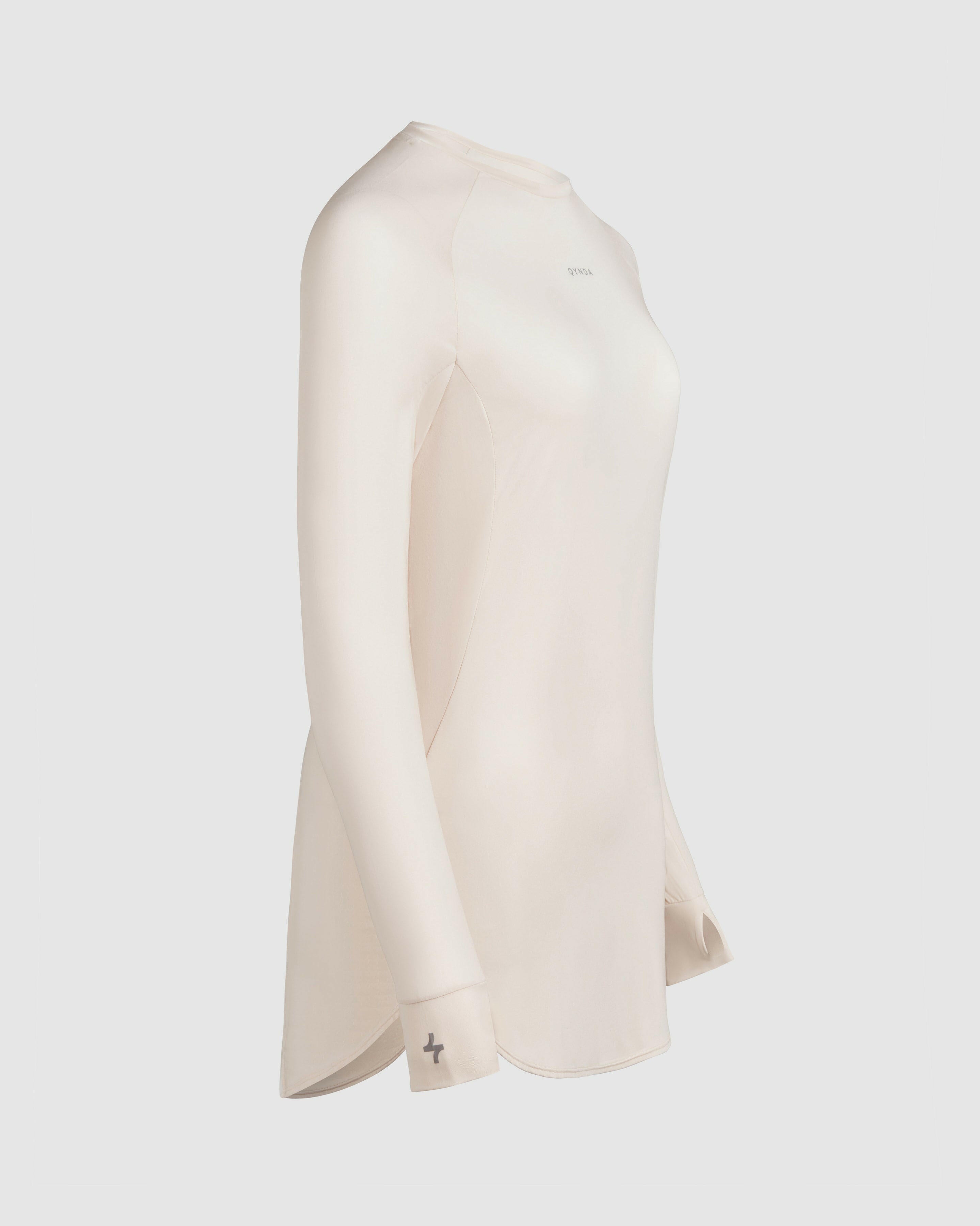 A modest shell MOD LONG SLEEVE T-SHIRT by Qynda on a mannequin featuring an extra long-sleeve design with a high neckline.
