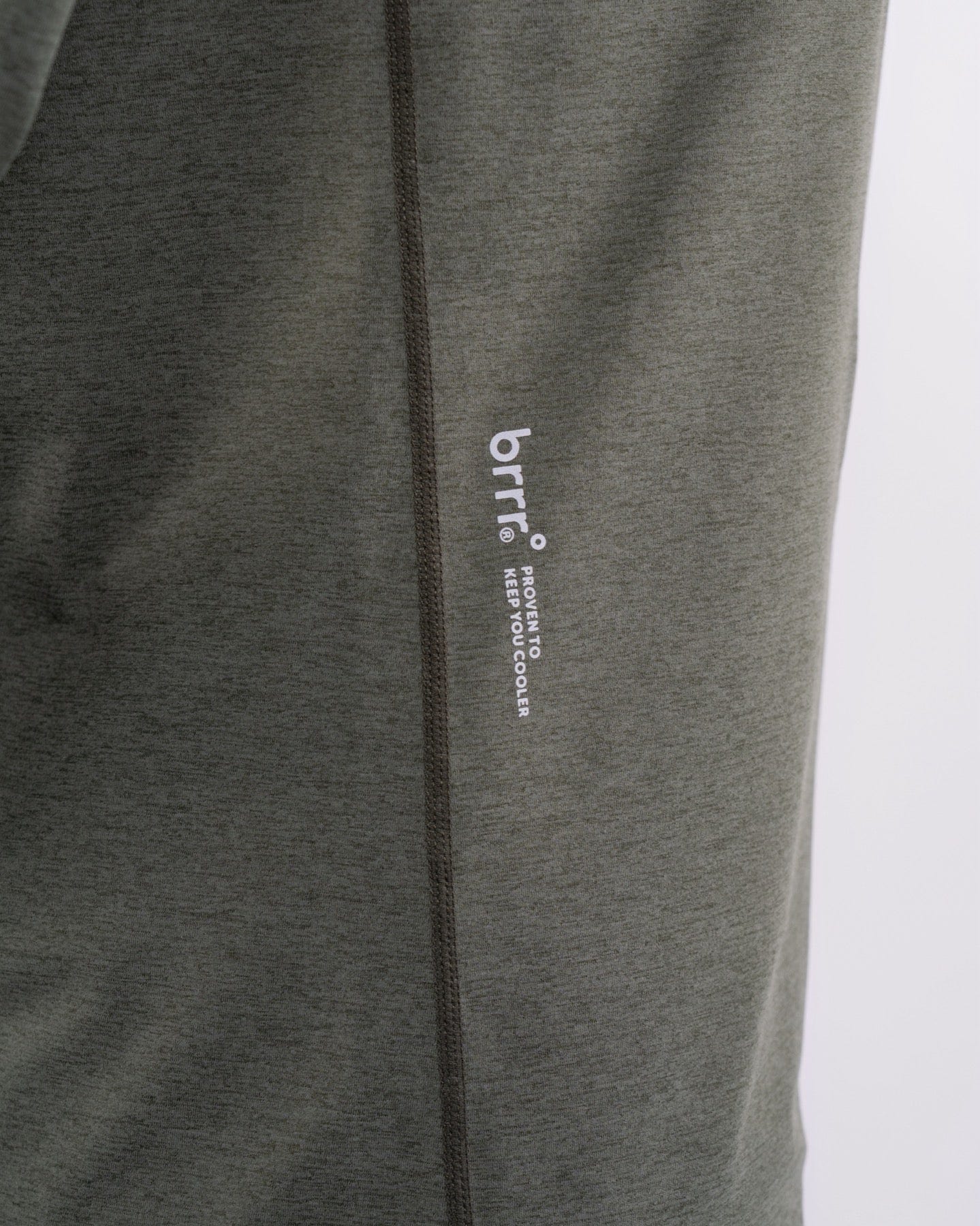 A close-up view of a gray, moisture-resistant garment with a zipper and a subtle logo, emphasizing minimalist design and details.