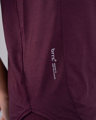 Close-up view of a maroon cooling tank top with a qynda logo on the side seam.