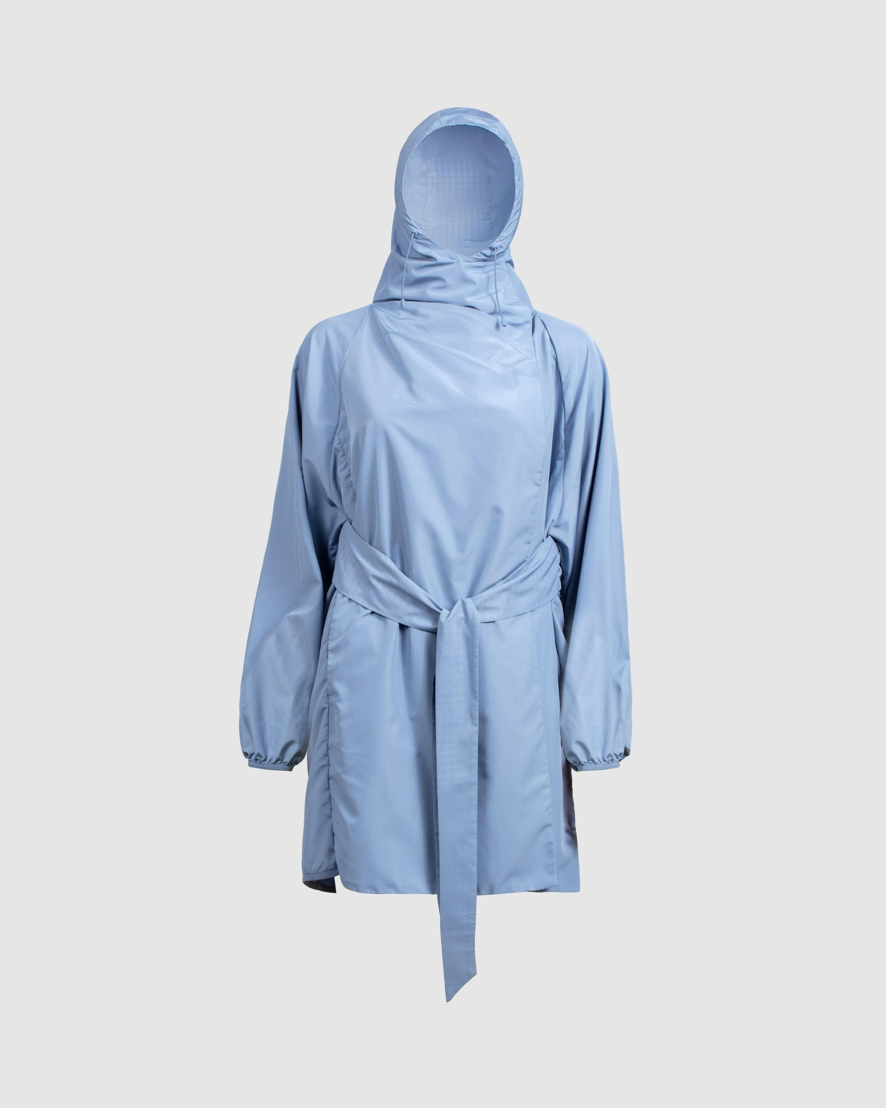 A lightweight Infinity Blue COOLDOWN coat by Qynda with a hood, displayed against a neutral background.