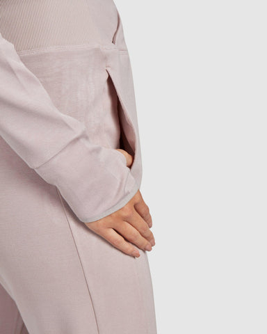 Close-up of a model dressed in a Beige JOG JOGGER, with a focus on the pocket detail and the hand casually slipped into the pocket.