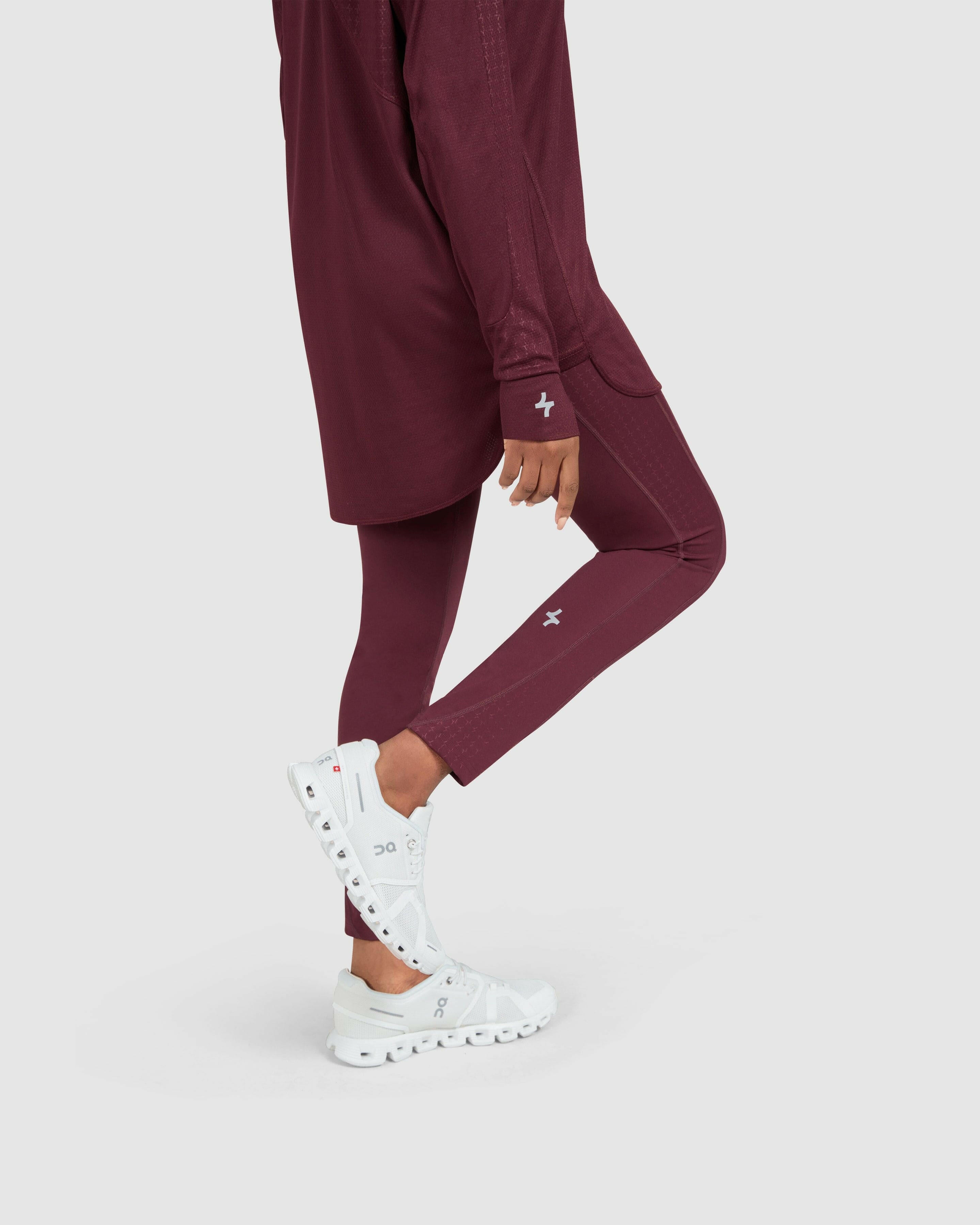 A model posing in a maroon Modest LADINA LEGGINGS.