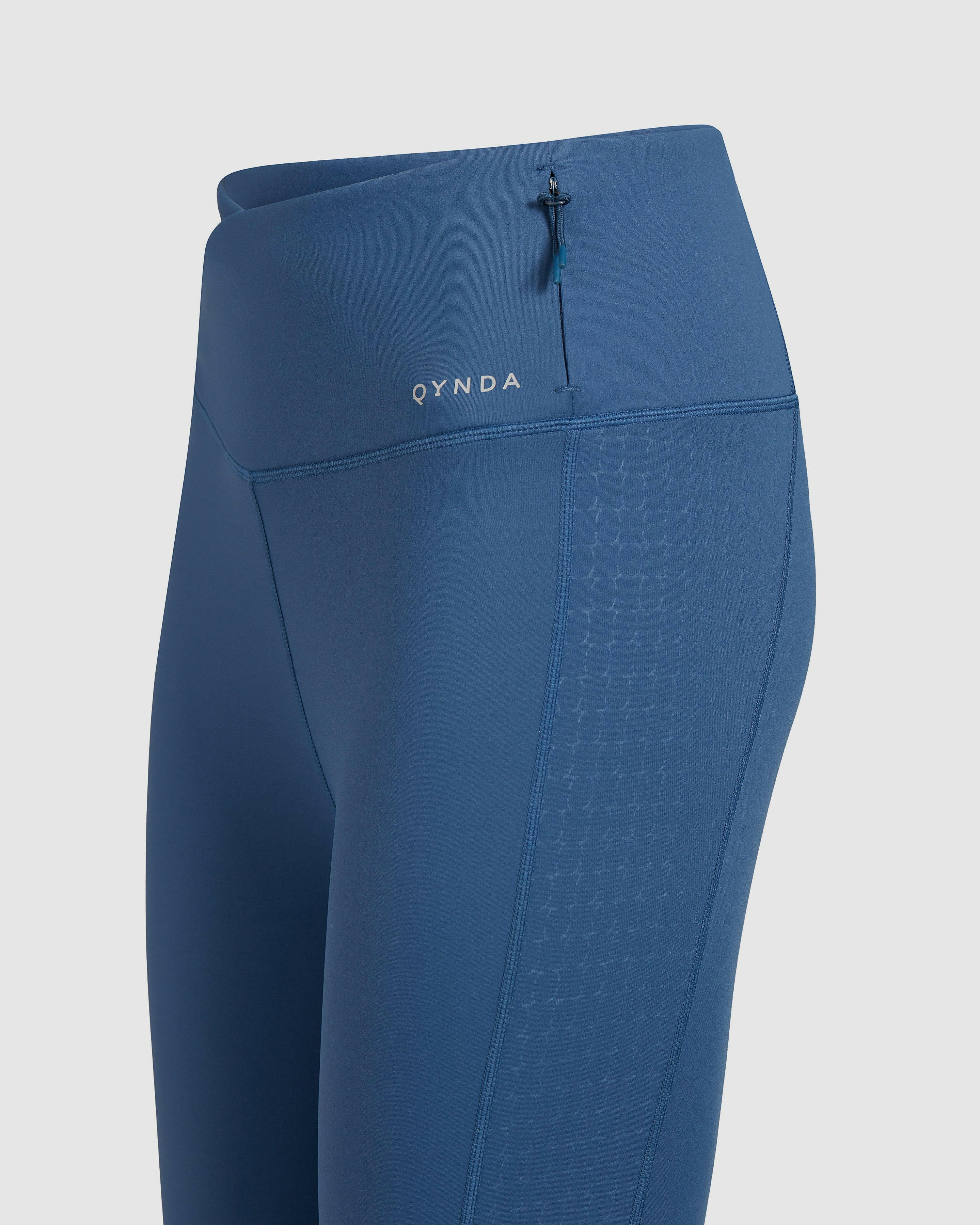 Close-up of a Dark Denim color Modest LADINA LEGGINGS featuring a subtle QYNDA brand logo and a drawstring waist detail.