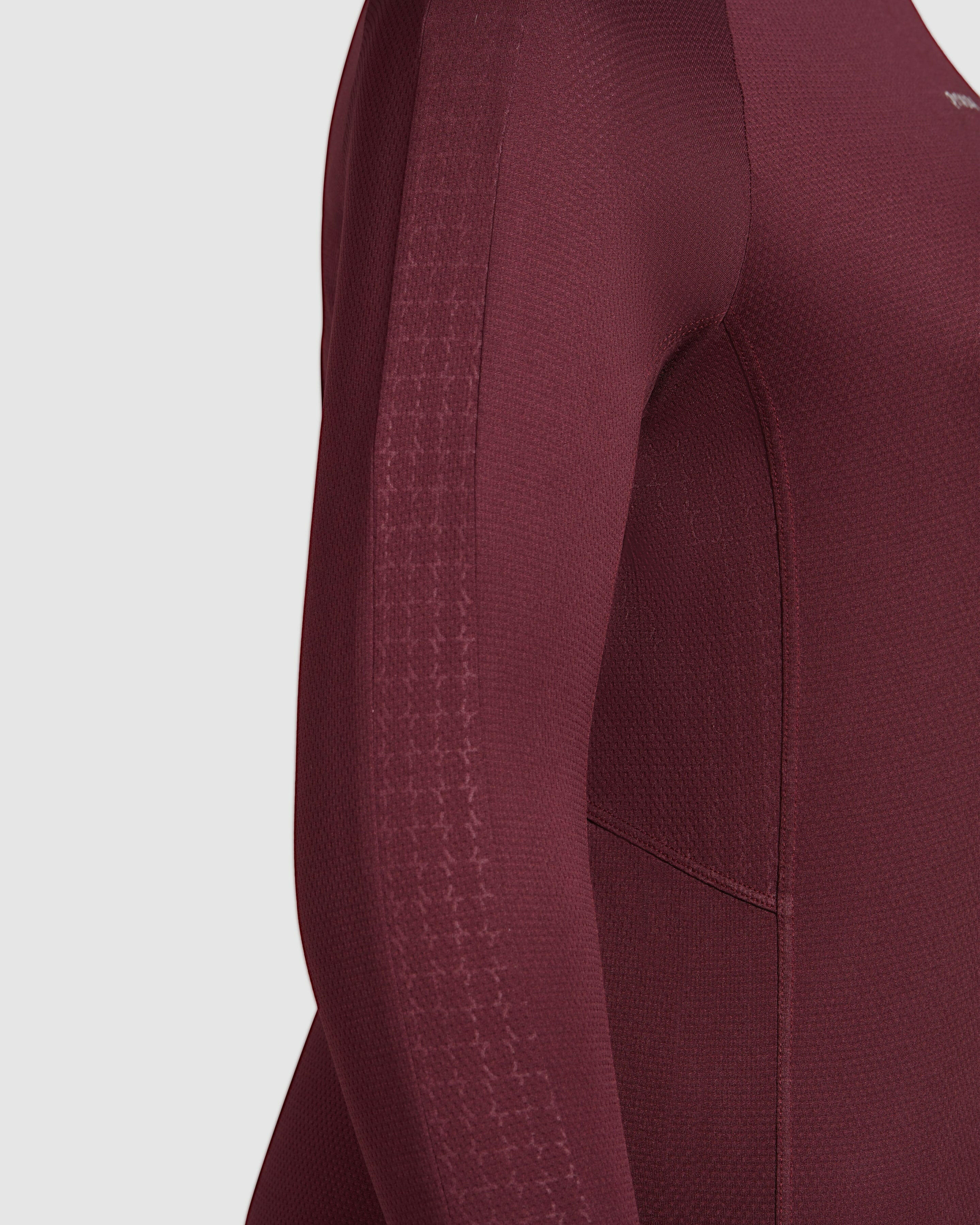 Close-up view of a ACT LONG SLEEVE T-SHIRT with detailed stitching and a qynda logo.