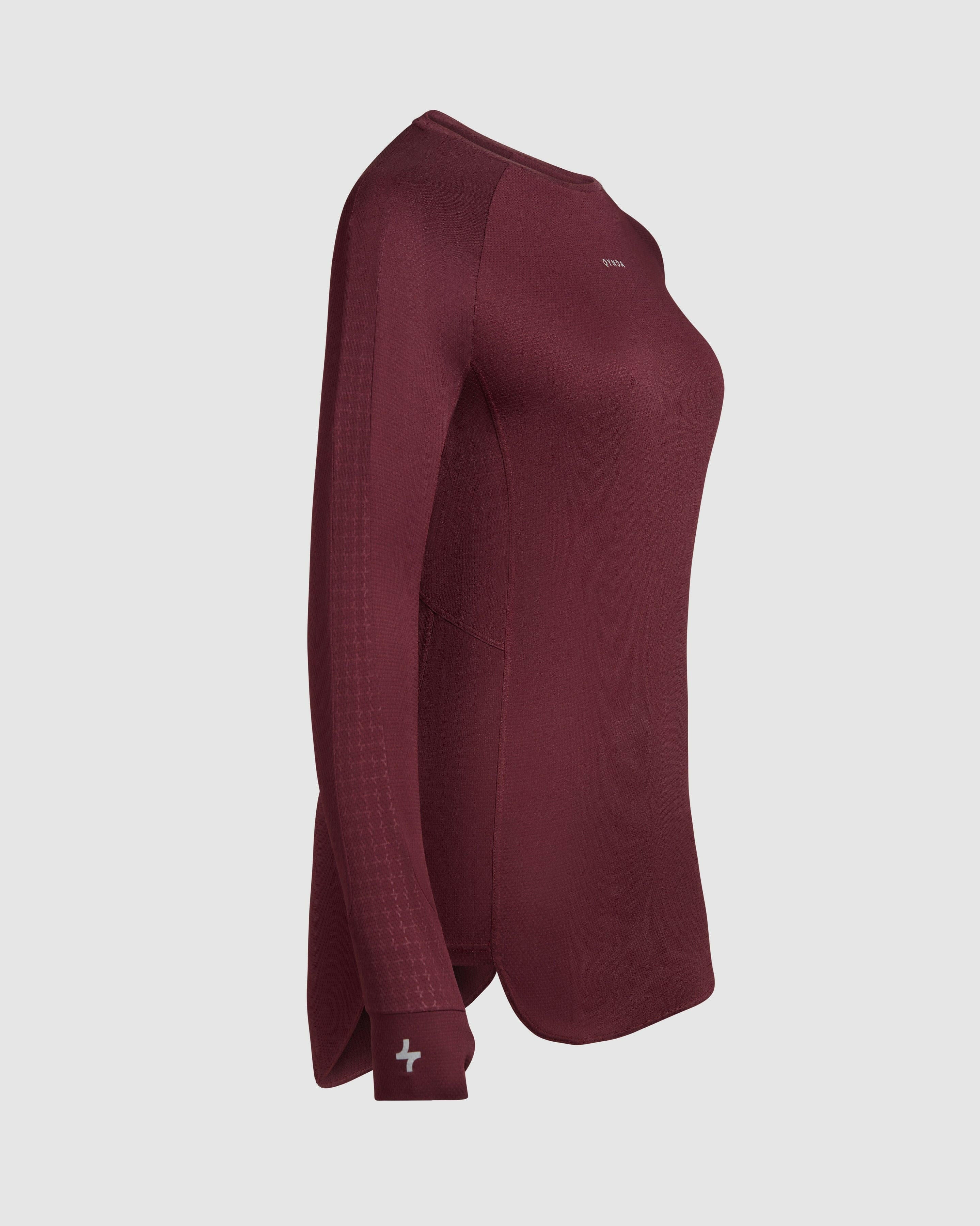 Side view of QYNDA ACT LONG SLEEVE T-SHIRT with a crew neck and moisture-wicking fabric displayed on an invisible mannequin against a neutral background.