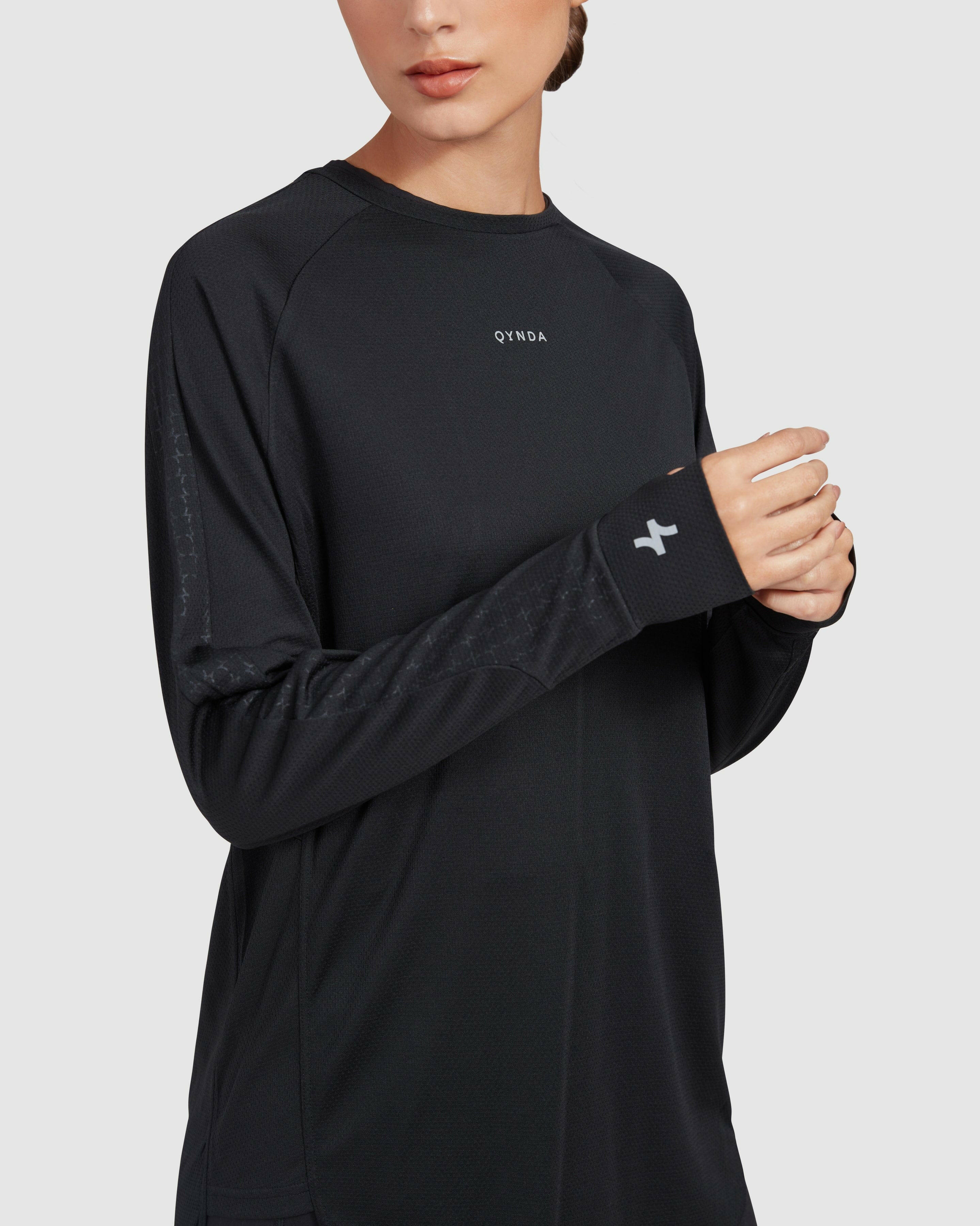 Close-up view of the stitching and fabric detail on a QYNDA active long sleeve t-shirt, showcasing the texture and design of the no see through material.