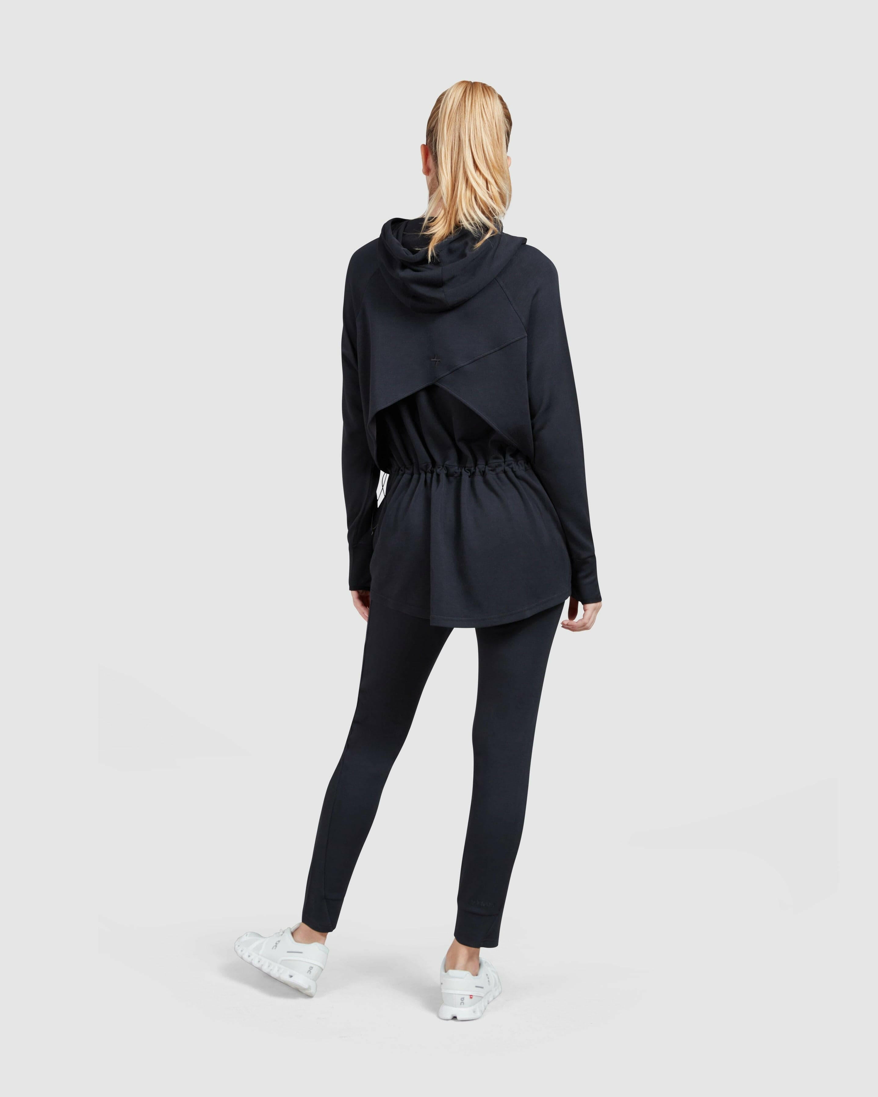 A model from behind in a Black coordinated Modest JOG JOGGER by Qynda.