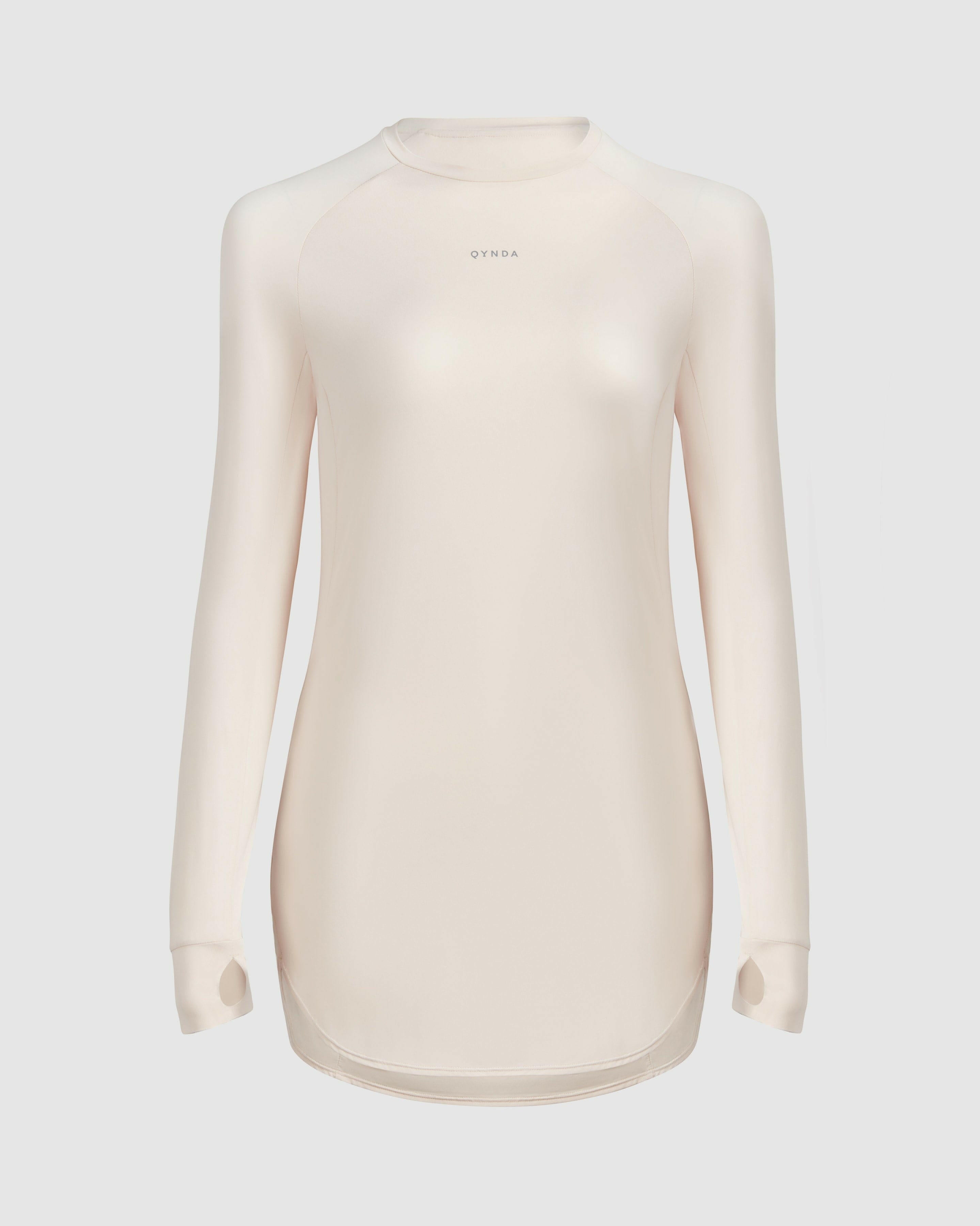 A, modest shell MOD LONG SLEEVE T-SHIRT by Qynda with a fitted design, prominently displaying a small Qynda logo on the chest.