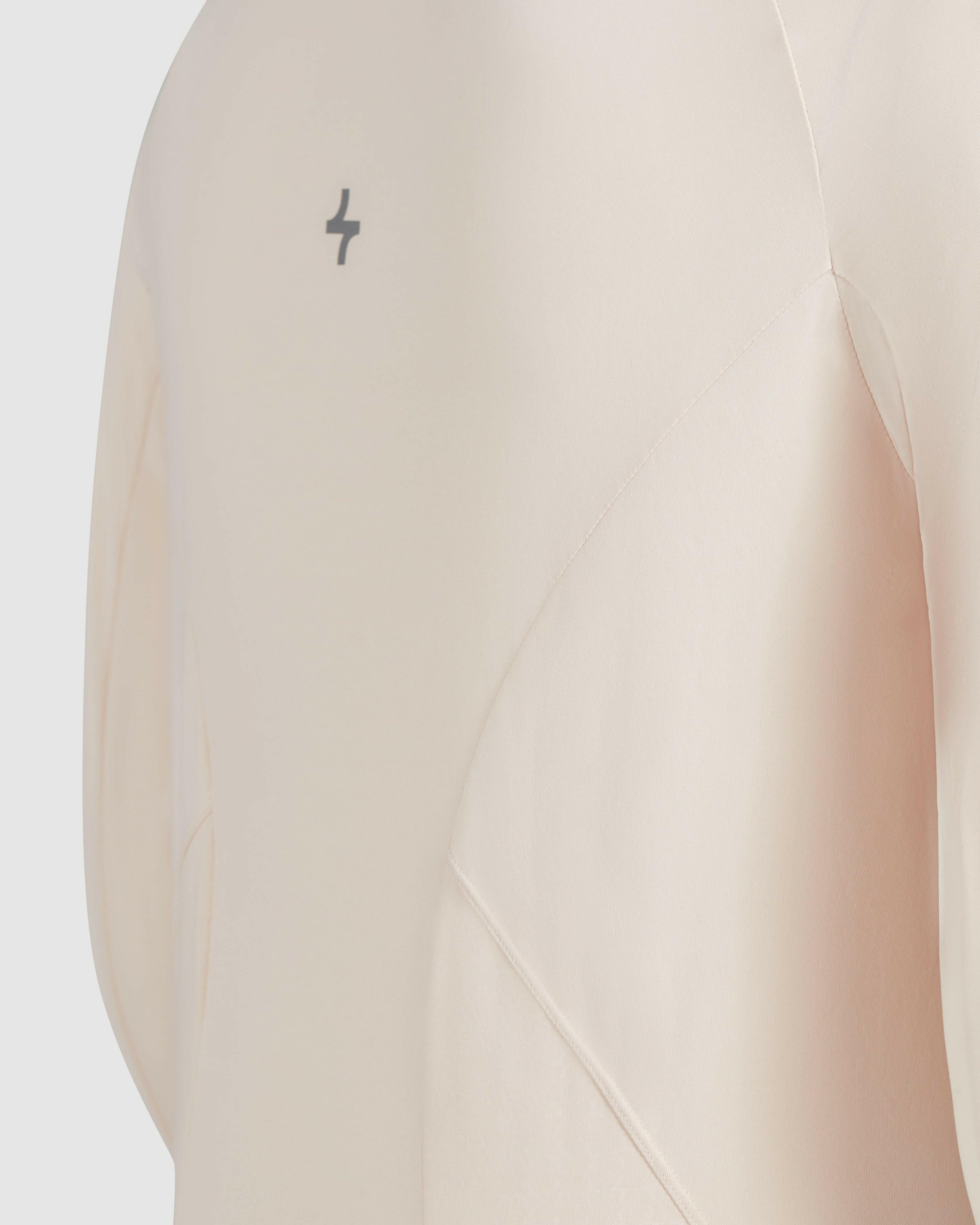 Close-up of modest shell MOD LONG SLEEVE T-SHIRT made from super light material, with a small QYNDA logo.