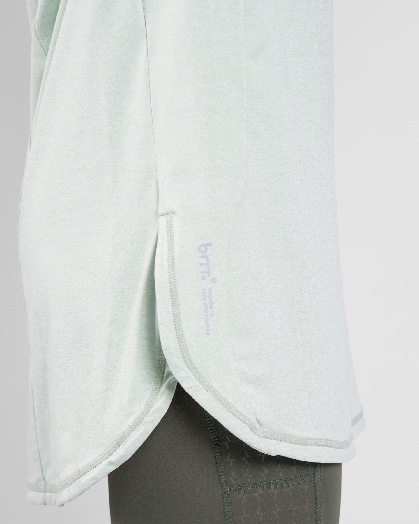 Close-up of Sage color high neck long sleeve shirt ARMA by Qynda with quick-drying fabric technology on a mannequin.