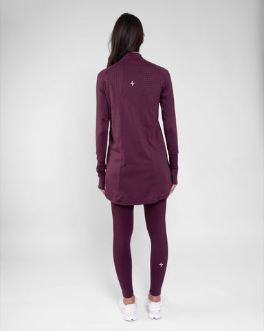 A model viewed from behind, wearing a maroon color long-sleeve ARMA shirt by Qynda.