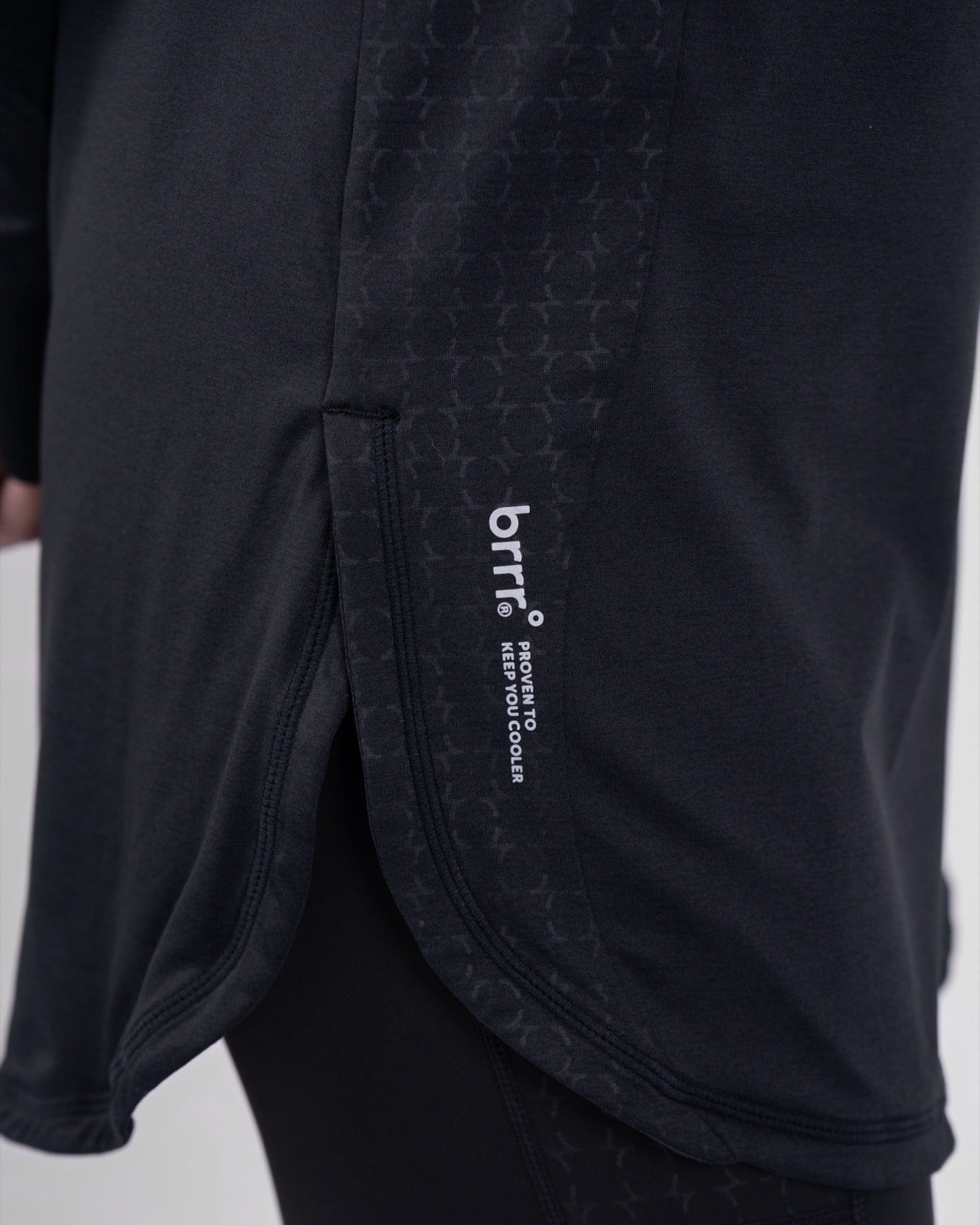 Close-up of a black high neck long sleeve shirt ARMA by Qynda featuring a subtle pattern.