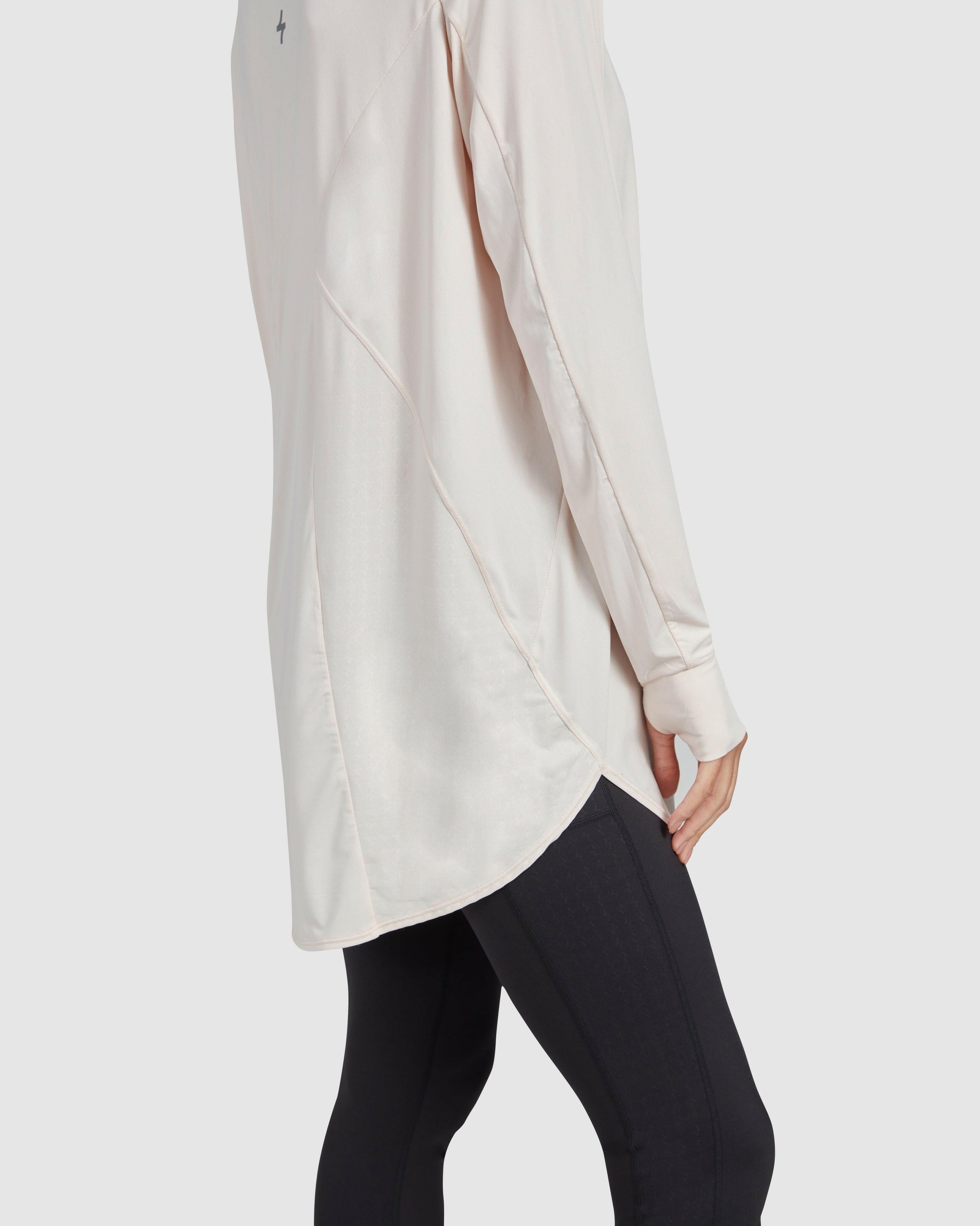 Close-up side view of a model wearing a modest shell MOD LONG SLEEVE T-SHIRT by Qynda with a unique textured pattern, crafted from super light material.