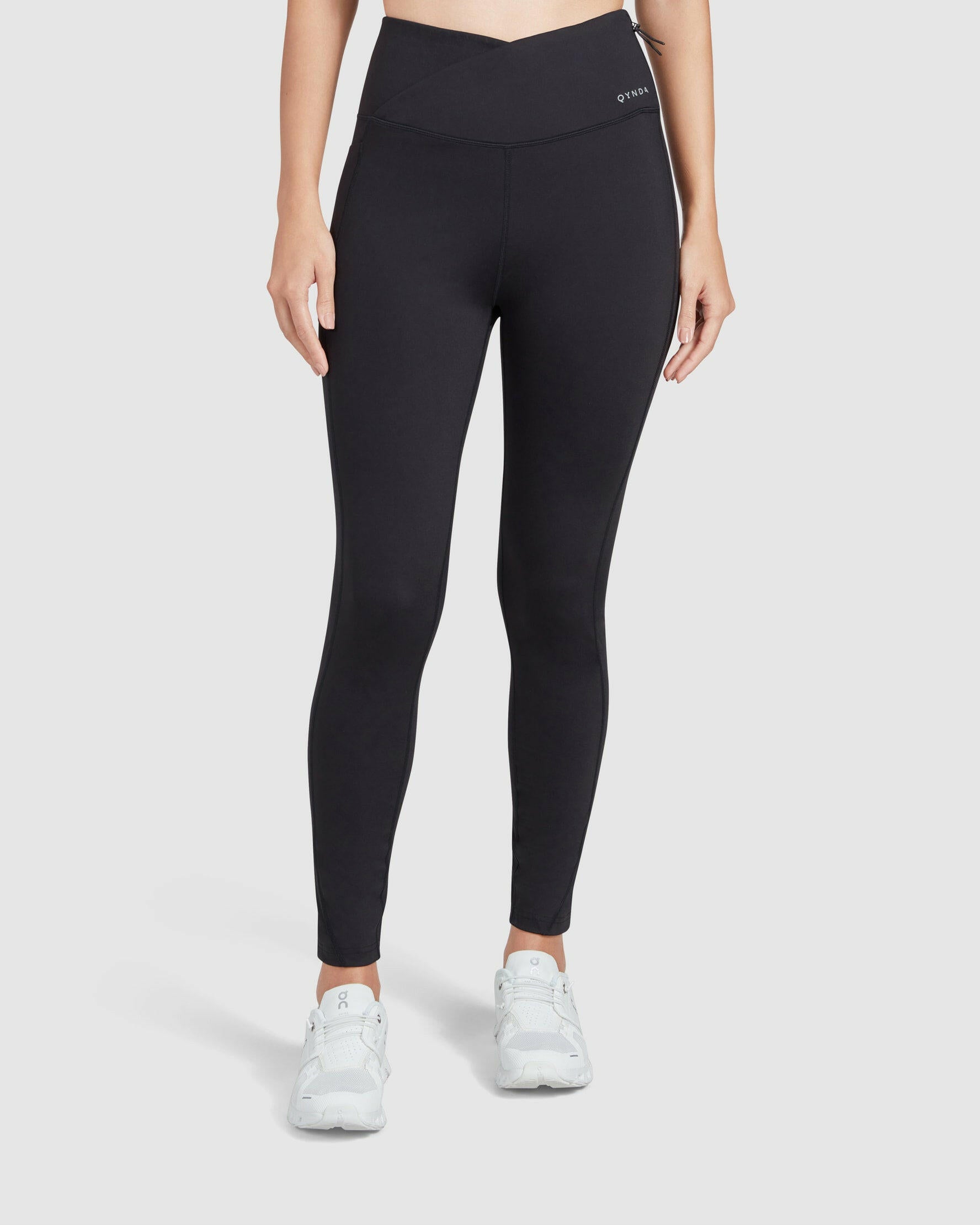 A model wearing black LADINA LEGGINGS and a FUNUQ hoodie stands against a plain background, showcasing the fit and style of athleisure wear.